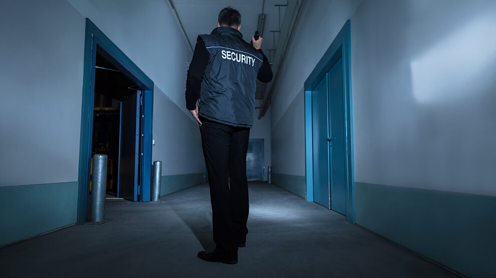 concierge security guard on patrol in empty commercial building in Essex 